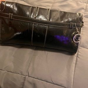 Black patten leather big buckle clutch, gently used.